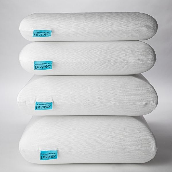 four different sizes of pillows stacked on top of one another